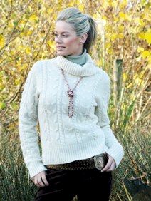 Young blonde model wearing pale cream coloured Aran sweater