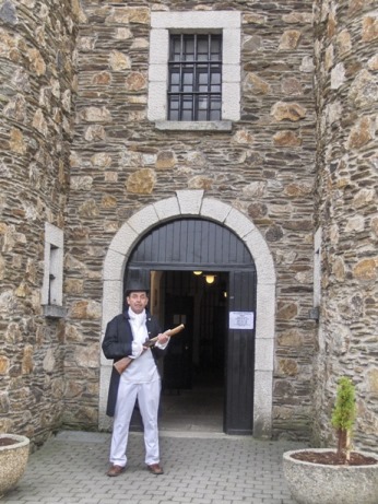 Entrance to the historic Wicklow Gaol, guarded, in character outfit, by the warden carrying a blunderbuss.