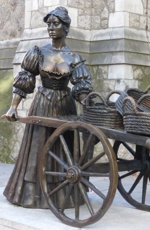 Bronze statue of Molly Malone, with her wheelbarrow, outside St Andrews church in Dublin City.