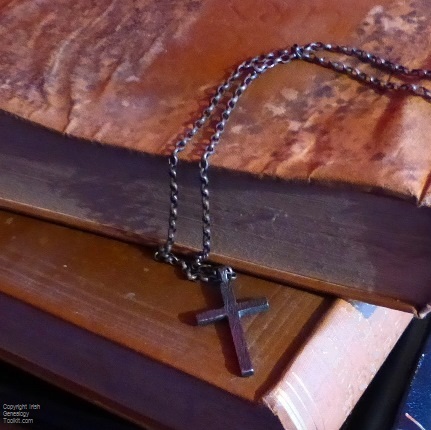 Protestant cross on chain draped over old Irish church registers