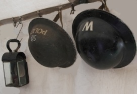 WW2 Home Guard helmets and lantern hanging on wall