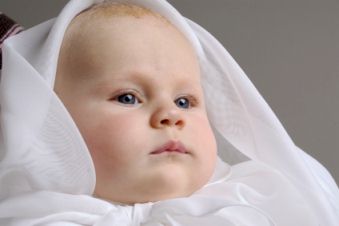 Baby dressed for baptism ceremony