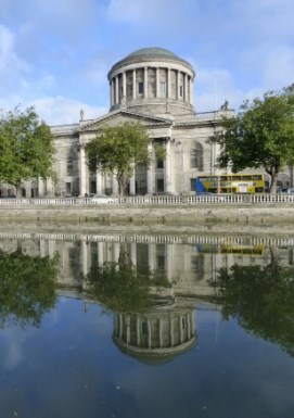 Four Courts building in Dublin, with reflection of portico and dome in River Liffey.