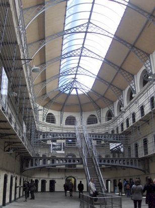 View of interior of Kilmainham Gaol in Dublin, with individual cells ringing each of the three stories encircling the atrium.