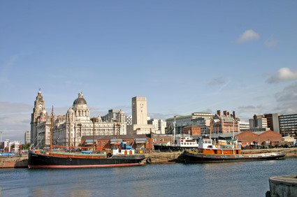 View of Liverpool Docks with river and boats in foreground and the city behind.